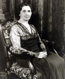 Black and white photo of Matilda Dodge Wilson sitting in an ornate chair.