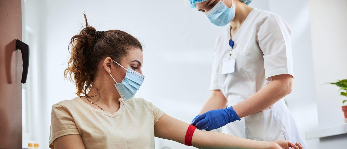 A medical professional drawing blood from a patient.